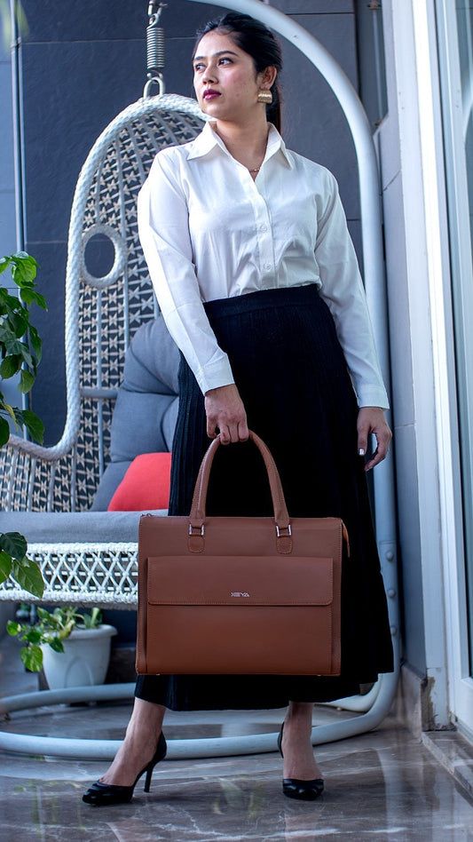 Woman holding a brown leather briefcase in an indoor setting